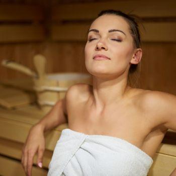 Woman Relaxing in Sauna to Release Toxins, Lower Blood Pressure, Improve Blood Circulation